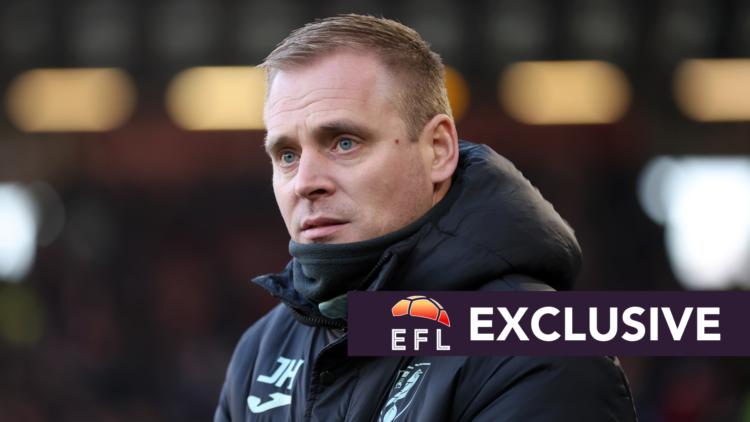Norwich City manager Johannes Hoff Thorup watches his team from the sidelines. Overlaid, exclusive branding.