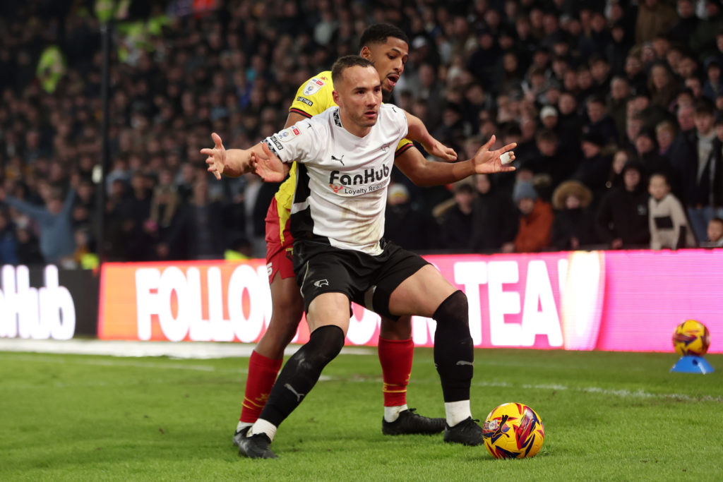 Kane Wilson of Derby County is challenged by Yasser Larouci of Watford during the Sky Bet Championship match between Derby County FC and Watford FC