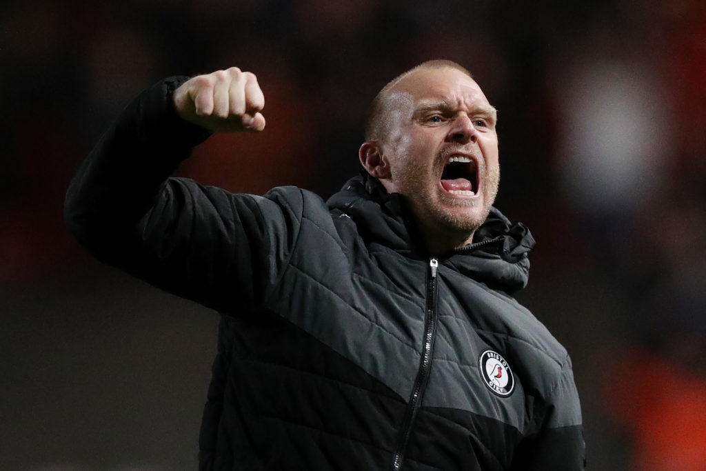 Liam Manning celebrates a win as Bristol City manager with a fist pump to the crowd
