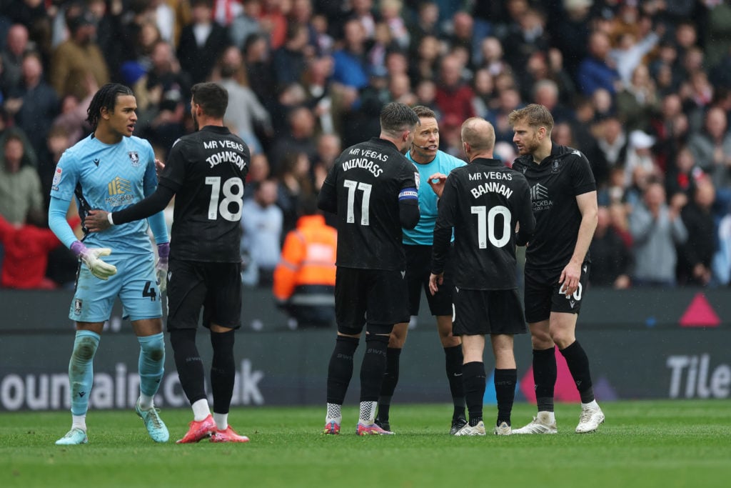 Pierce Charles of Sheffield Wednesday is consoled by team mate Marvin Johnson as Referee Stephen Martin speaks to Josh Windass, Barry Bannan and Stuart Armstrong of Sheffield Wednesday
