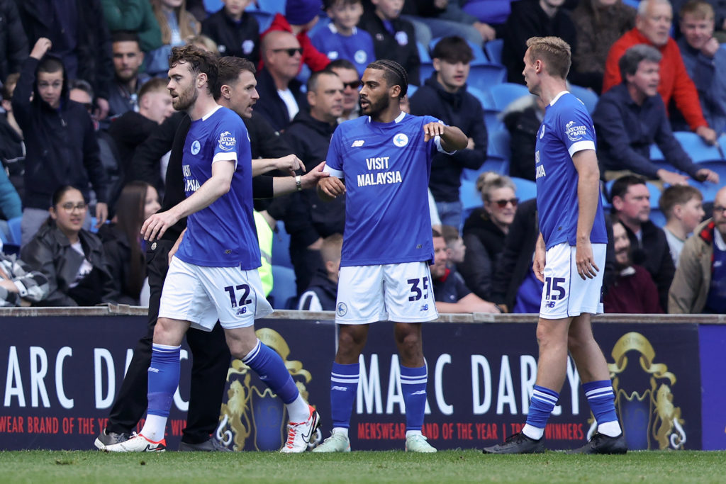 Aaron Ramsey, Interim Manager of Cardiff City, speaks with Andy Rinomhota and Sivert Mannsverk during the Championship match between Cardiff City and Oxford United FC
