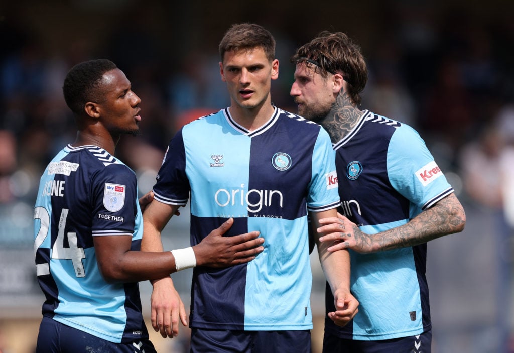 Richard Kone, Caleb Taylor and Sonny Bradley of Wycombe Wanderers