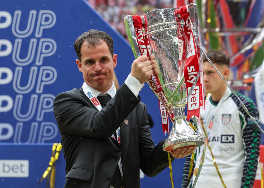 Regis Le Bris holds Championship play-off final trophy