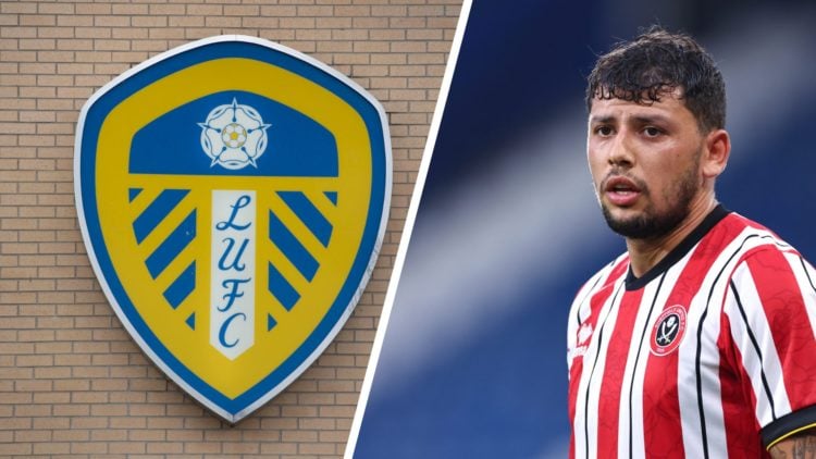 Leeds United badge on a wall. Sheffield United's Gustavo Hamer looks on.