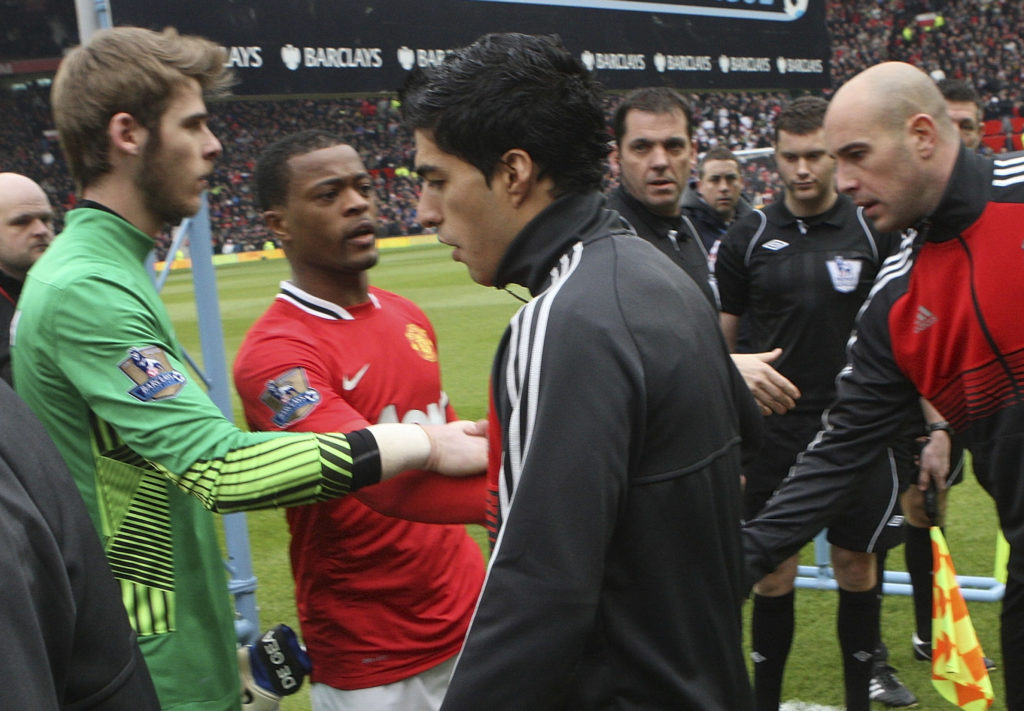 Luis Suarez of Liverpool refuses to shake the hand of Patrice Evra of Manchester United ahead of the Barclays Premier League match between Manchester United and Liverpool at Old Trafford