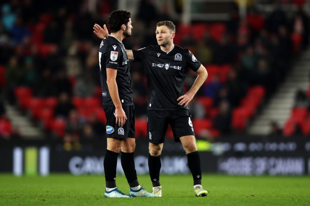 Sondre Tronstad and Lewis Travis talking on the pitch for Blackburn Rovers against Stoke City.