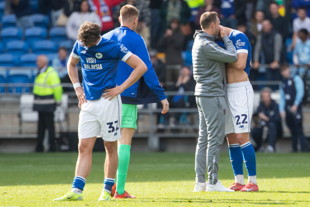 Ollie Tanner (L) and Yousef Salech of Cardiff City (R) react at full time as they get relegated to League One during the Sky Bet Championship match between Cardiff City and West Bromwich Albion