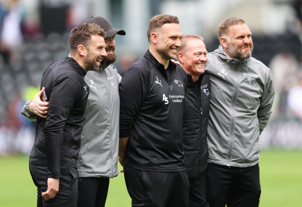 John Eustace, Manager of Derby County celebrates with his coaching staff after avoiding relegation after Derby County draw 0-0 with Stoke City