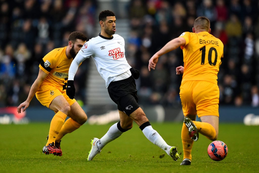 Leon Best of Derby passes under pressure from Richard Brodie of Southport during the FA Cup Third Round match between Derby County and Southport FC at iPro Stadium.