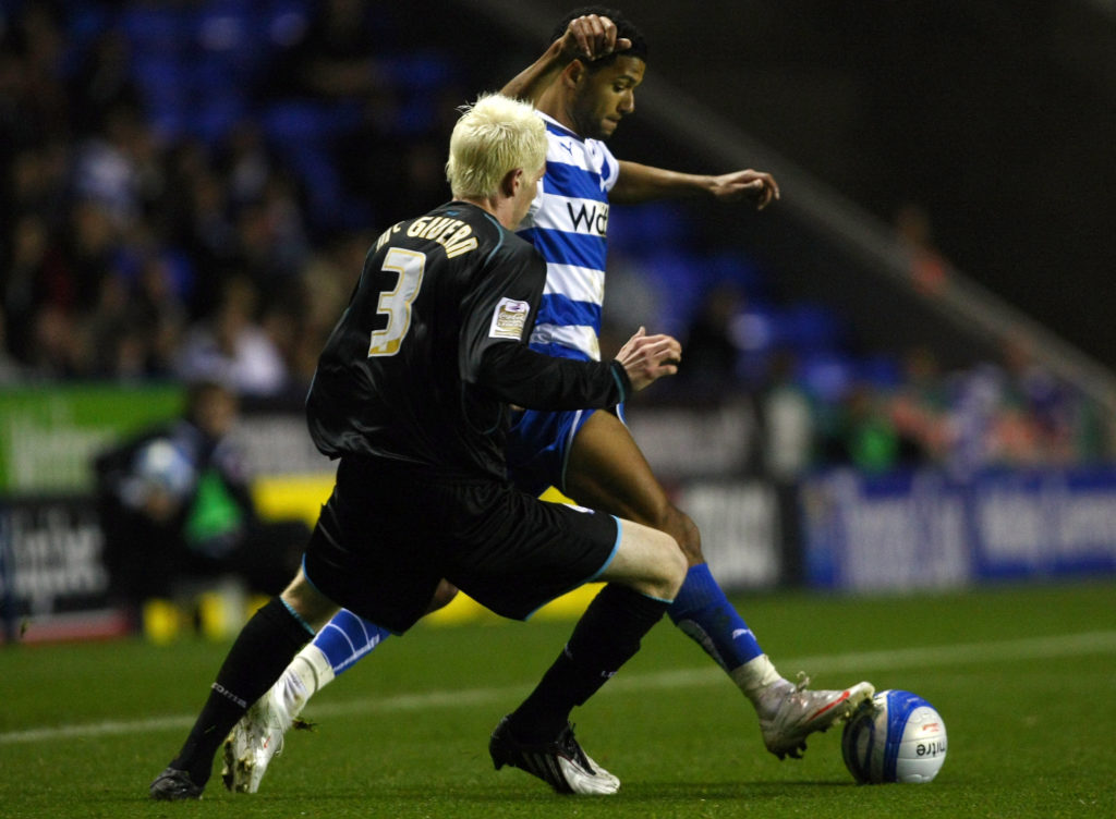 Ryan McGivern challenges Jobi McAnuff during Reading vs Leicester City