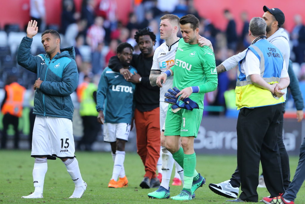 Alfie Mawson of Swansea City and Lukasz Fabianski of Swansea City dejected at full time as relegation from the Premier League is confirmed during the Premier League match between Swansea City and Stoke City