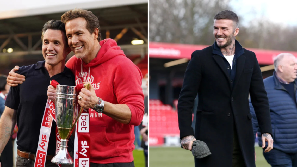 Left, Rob McElhenney and Ryan Reynolds, co-owners of Wrexham AFC, pose for a photo with the trophy following the club's promotion to the Sky Bet Ch...