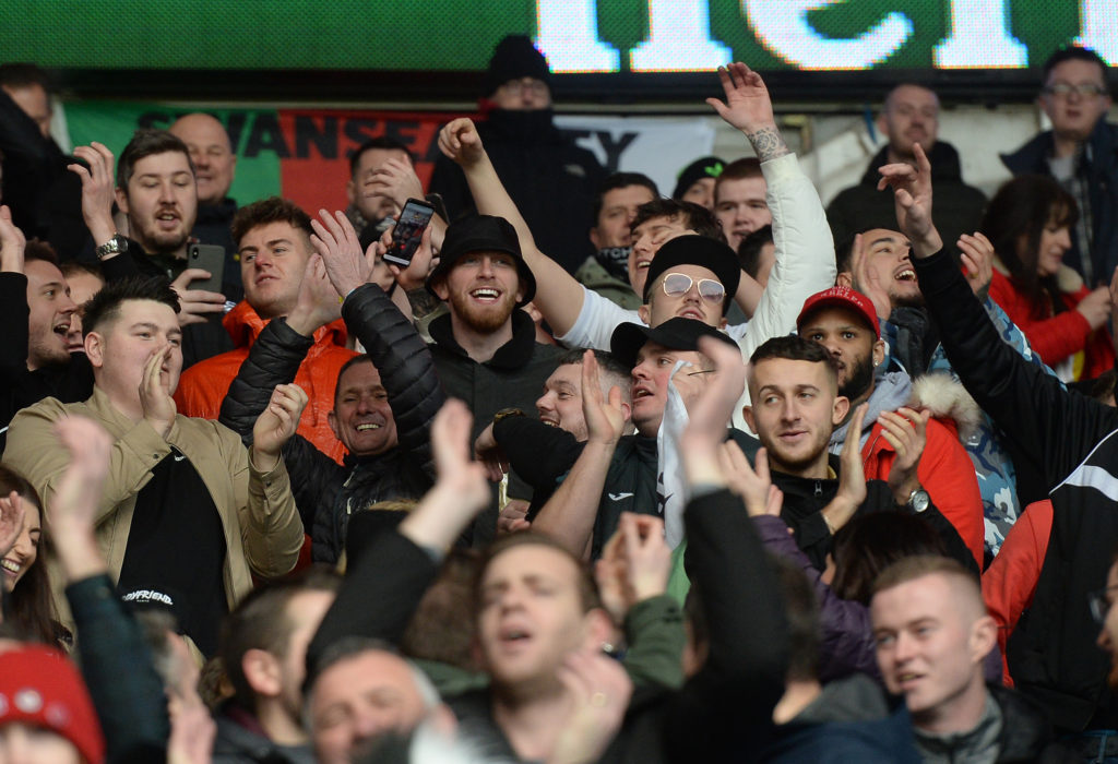 Sheffield United player Oli McBurnie stands in amongst the Swansea City fans