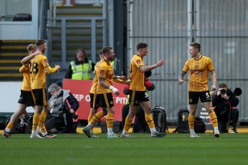 James Clarke of Newport County celebrates with teammates after scoring his team's first goal during the Emirates FA Cup Third Round match between Newport County and Eastleigh