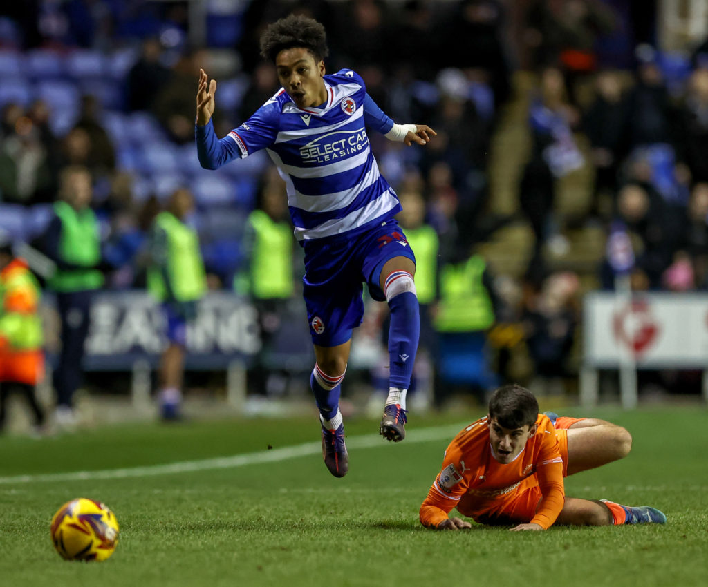 Andre Garcia leaps over Rop Apter during Reading vs Blackpool