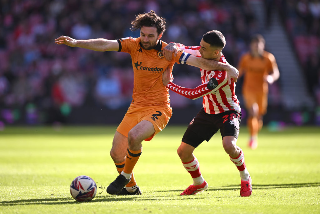 Hull City player Lewie Coyle is challenged by Enzo Le Fee of Sunderland