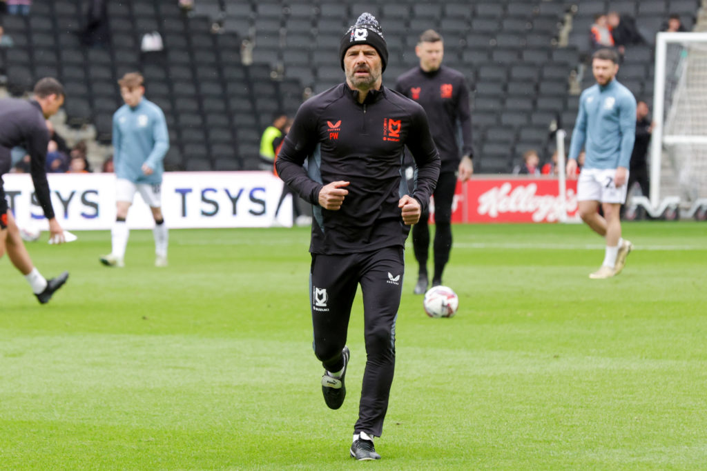 Paul Warne runs to the dugout before MK Dons vs Notts County
