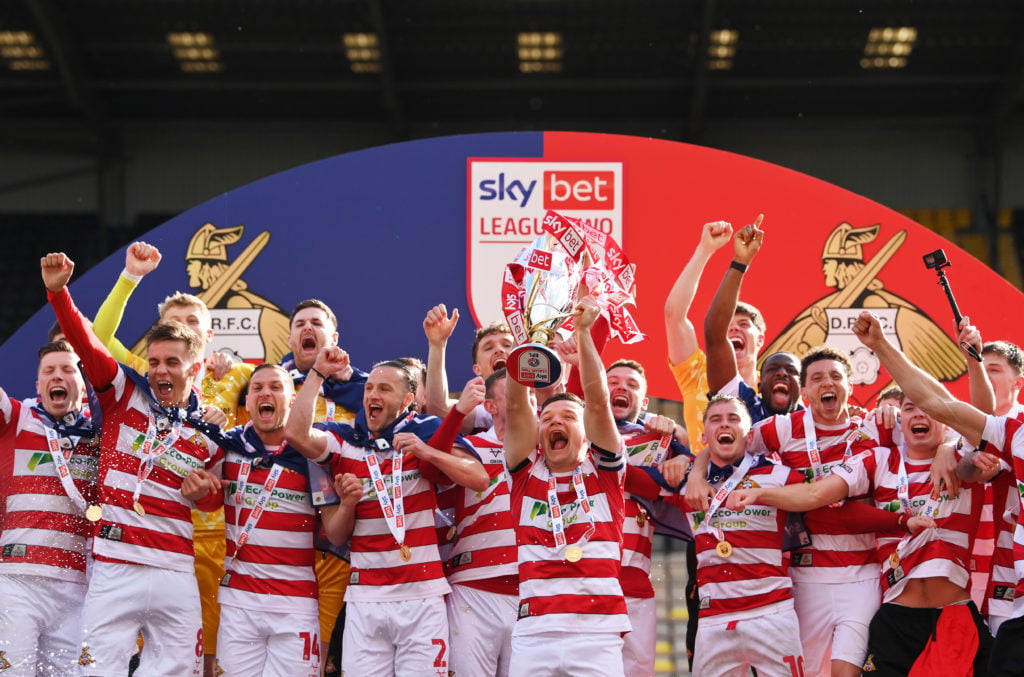 Owen Bailey of Doncaster Rovers lifts the Sky Bet League Two trophy, after the teams 2-1 victory, which confirmed that the team has won the Sky Bet League Two and promotion to the Sky Bet League Onefollowing during the Sky Bet League Two match between Notts County and Doncaster Rovers