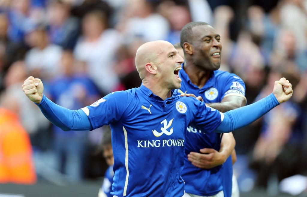 Esteban Cambiasso celebrates with Wes Morgan after scoring for Leicester City against Manchester United