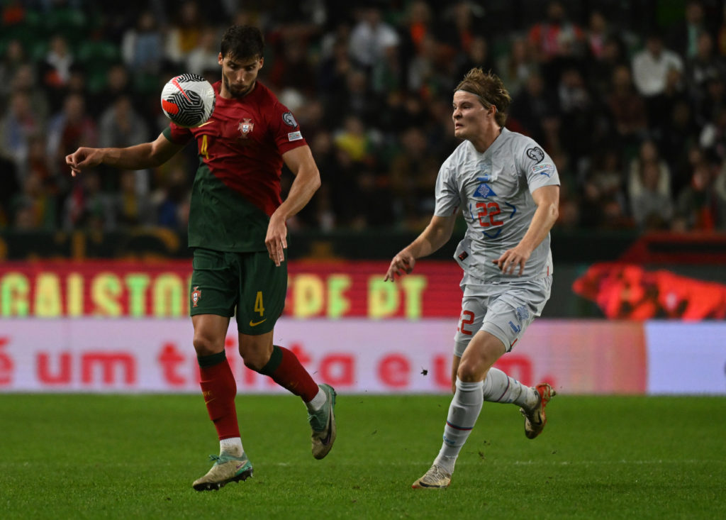 Ruben Dias of Portugal and Andri Guðjohnsen of Iceland challenge for the ball during the UEFA EURO 2024 European qualifier match between Portugal and Iceland