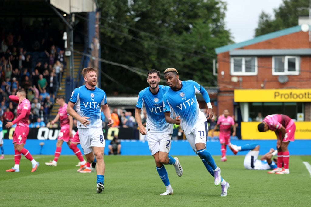 Malik Mothersille of Stockport County celebrates scoring his team's first goal with teammate Corey O'Keeffe during the Sky Bet League One match between Stockport County FC and Bolton Wanderers
