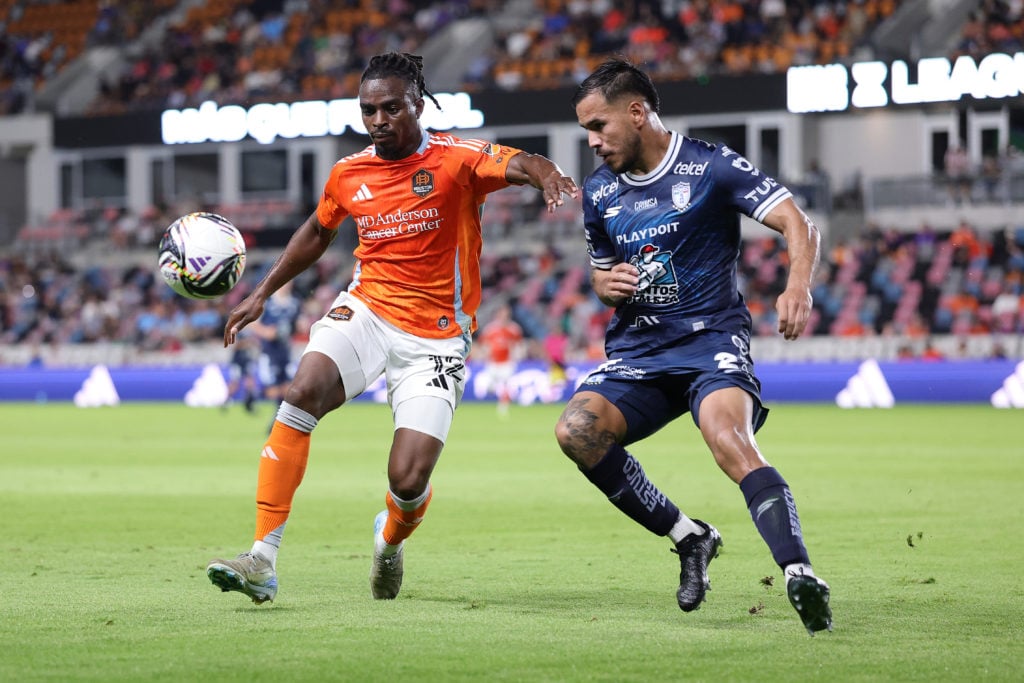 Toyosi Olusanya #12 of Houston Dynamo FC battles for the ball with Sergio Barreto #2 of CF Pachuca during the second half of the Leagues Cup Phase One match between Houston Dynamo FC and CF Pachuca