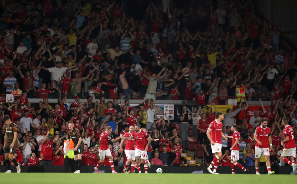 Ollie Palmer of Wrexham celebrates scoring his team's third goal with teammate James McClean during the Carabao Cup first round match between Wrexham and Hull City