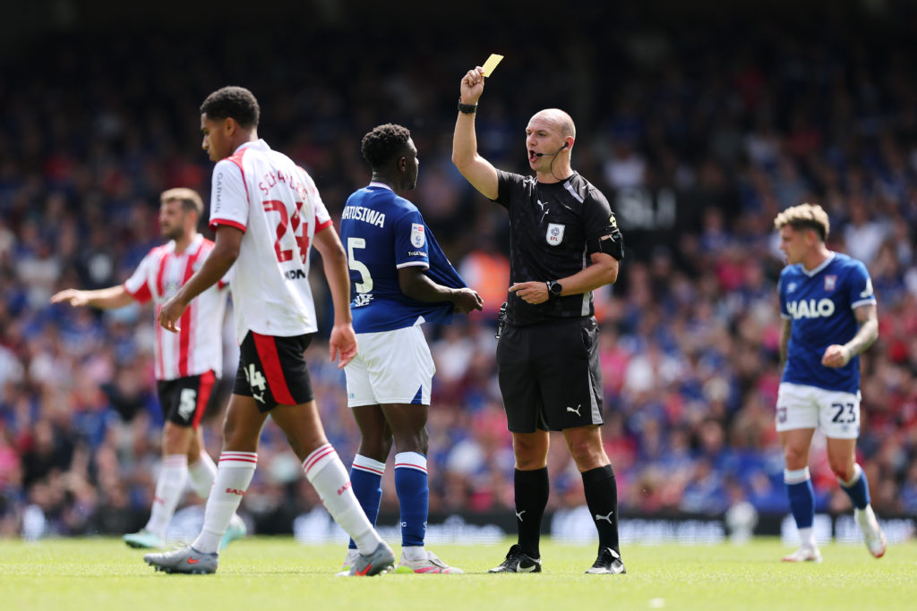 Referee Robert Madley shows a yellow card to Azor Matusiwa of Ipswich Town during the Sky Bet Championship match between Ipswich Town and Southampton