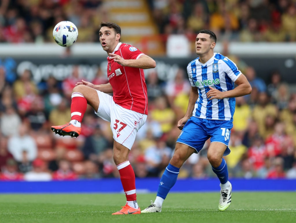 Matty James of Wrexham controls the ball whilst under pressure from Bailey-Tye Cadamarteri