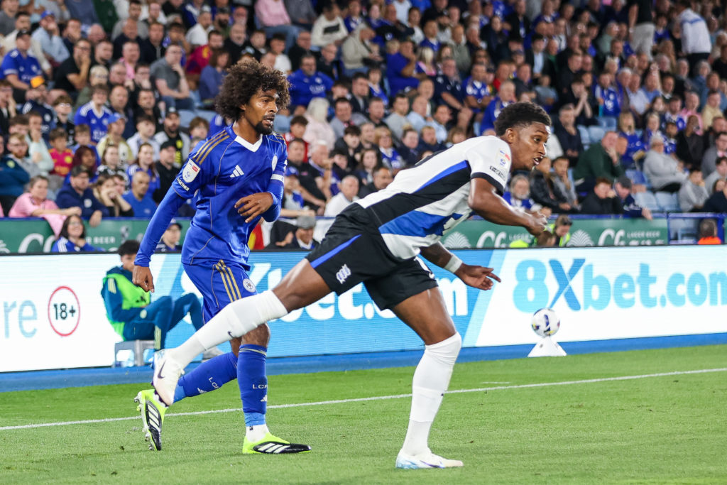 Hamza Choudhury of Leicester City clears the ball away from Demarai Gray