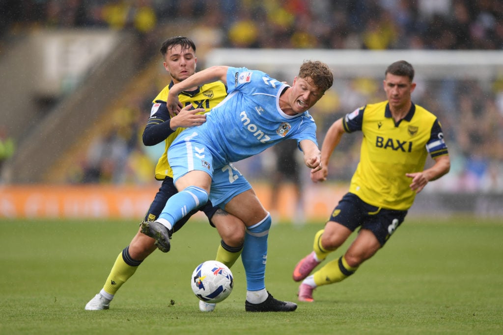 Victor Torp of Coventry City battles for possession with Tyler Goodrham of Oxford United