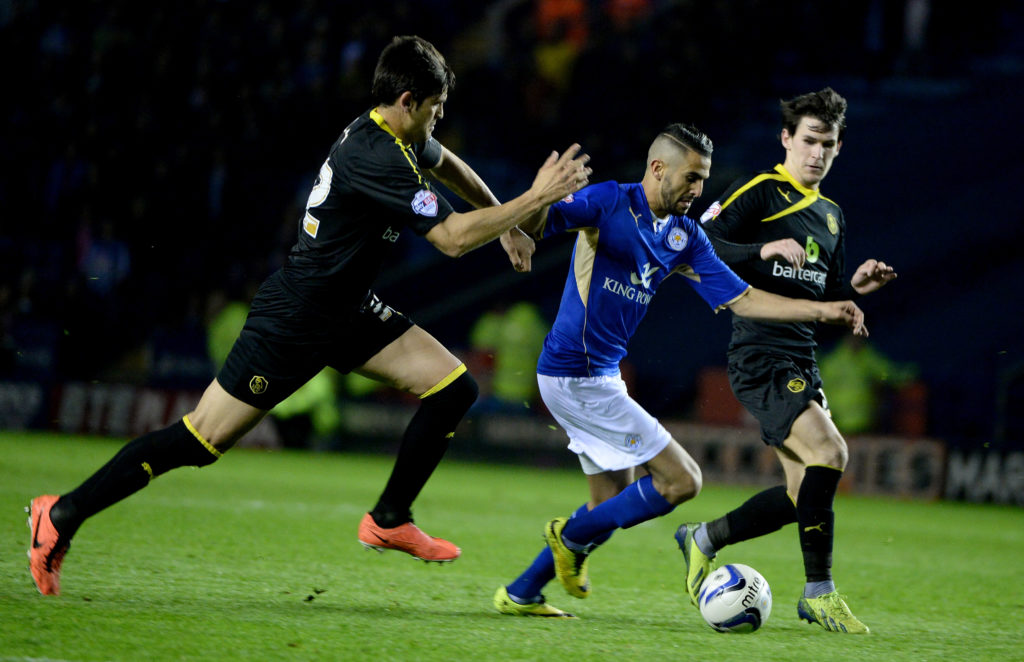 Riyad Mahrez shrugs off tackles from Miguel Llera and Kieran Lee during Leicester City vs Sheffield Wednesday