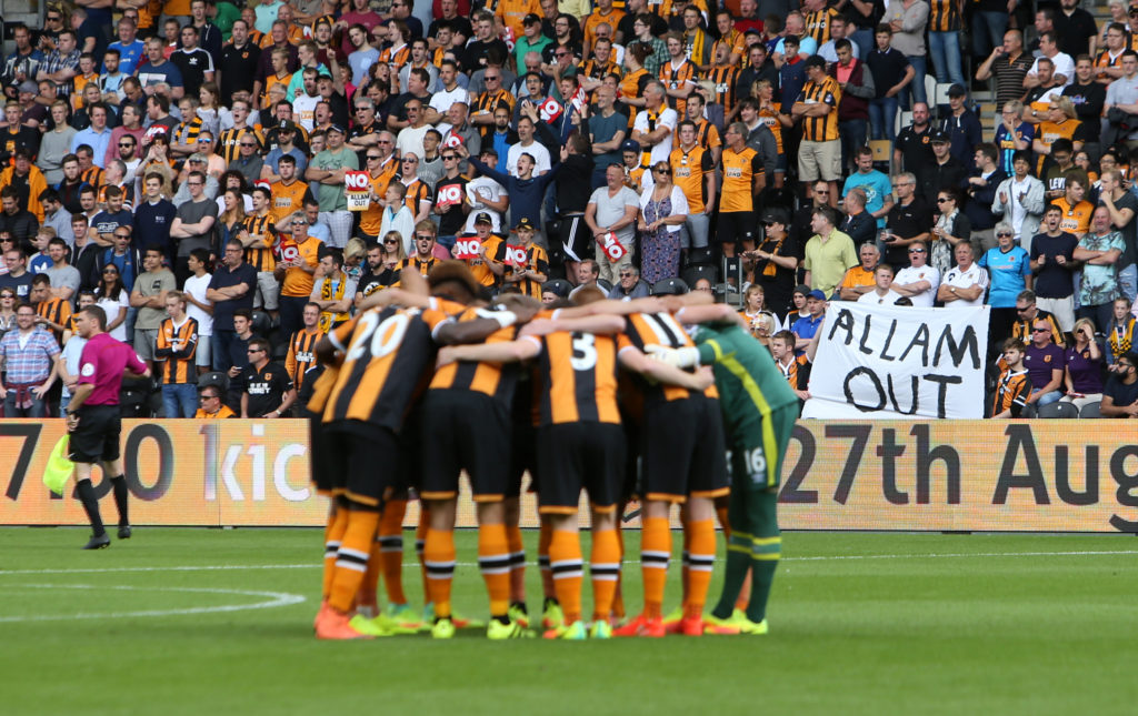 Hull City team talk in front of an Allam out poster ahead of the Premier League match between Leicester City and Hull City