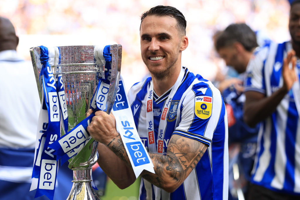Lee Gregory holding the League One play-off final trophy