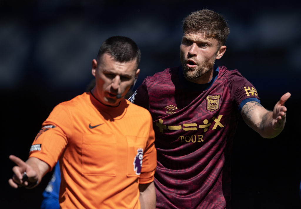 Referee Lewis Smith and Cameron Burgess of Ipswich Town during the Premier League match between Everton FC and Ipswich Town FC