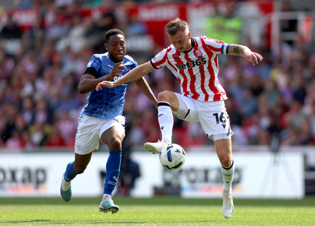 Ben Wilmot of Stoke City is challenged by Ebou Adams of Derby County
