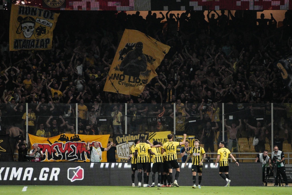 Playes and fans AEK Athens FC celebrate a goal