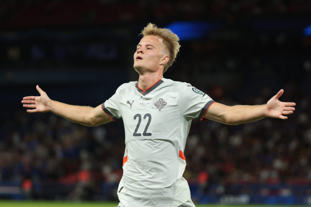 Andri Gudjohnsen of Iceland scores against France