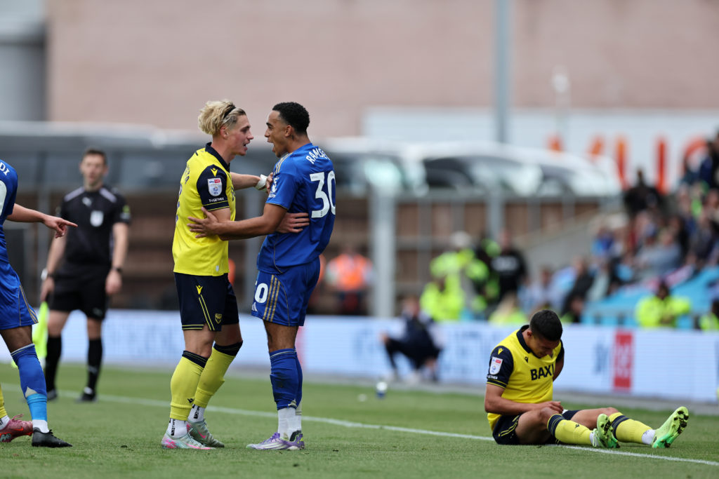Aaron Ramsey of Leicester City and Przemysaw Pacheta of Oxford United exchange words
