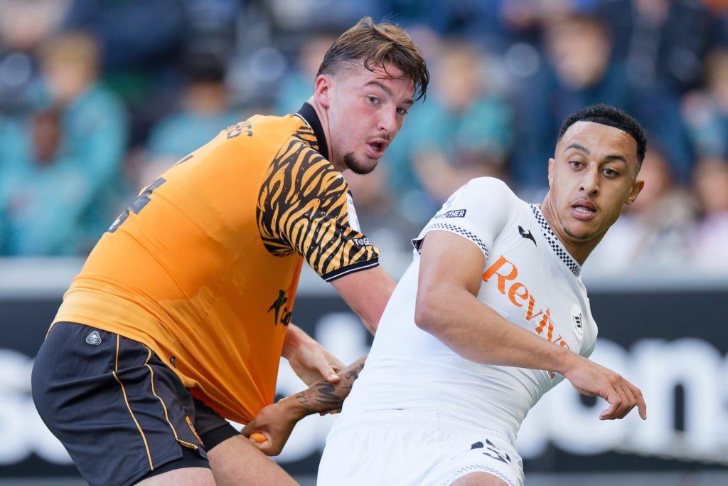 Charlie Hughes of Hull City challenges Adam Idah of Swansea City