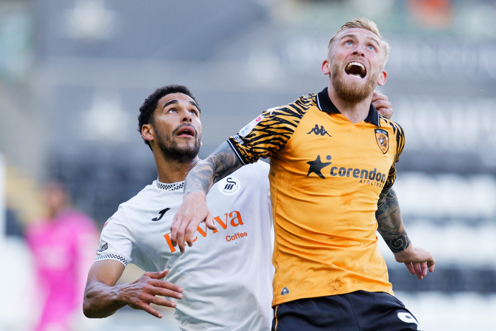 Ben Cabango of Swansea City challenges Oli McBurnie of Hull City