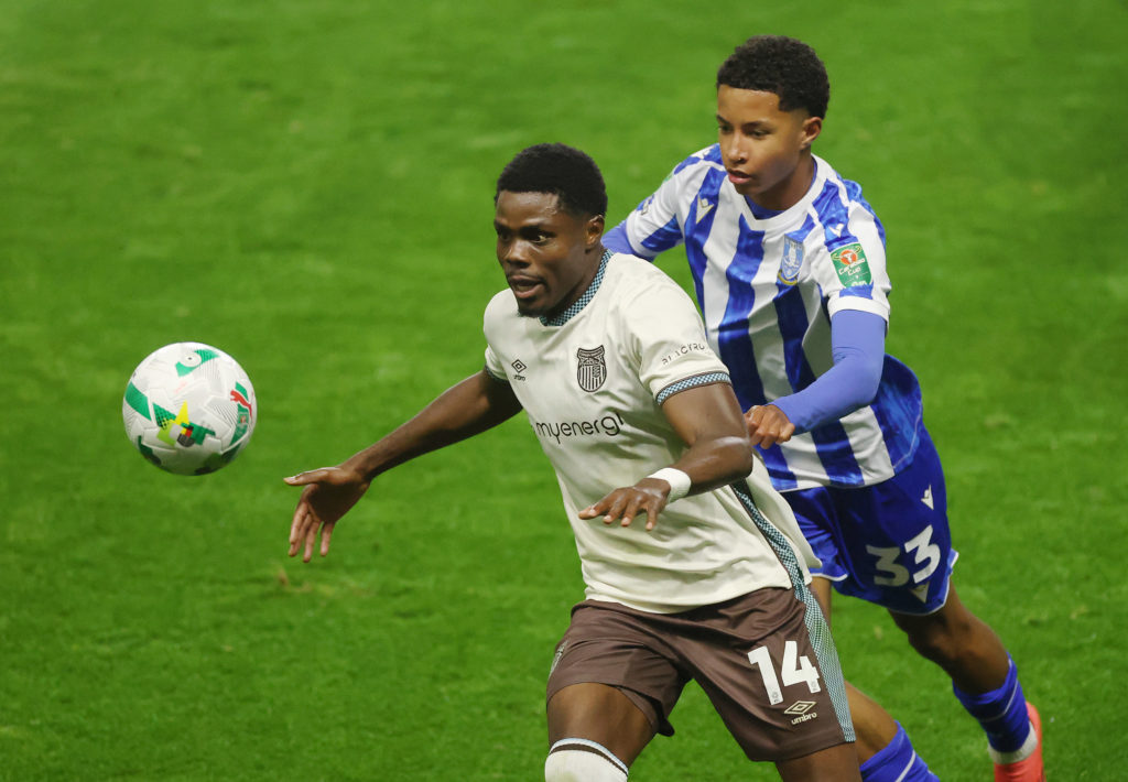 Justin Amaluzor of Grimsby Town is challenged by Yisa Alao of Sheffield Wednesday during the Carabao Cup Third Round match between Sheffield Wednesday and Grimsby Town