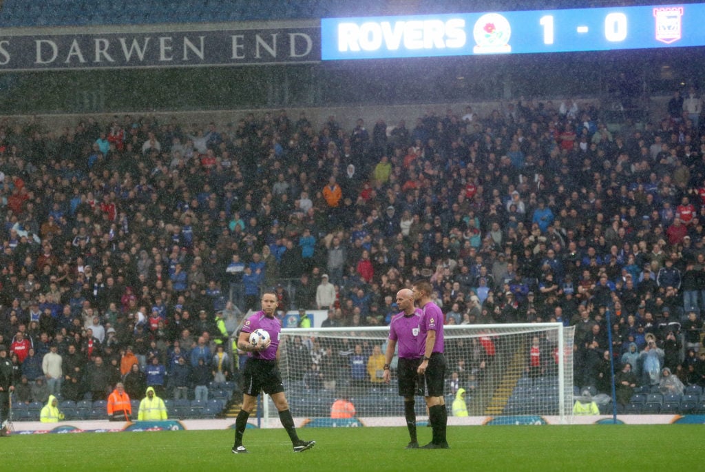 Referee Stephen Martin inspects the waterlogged pitch at Ewood Park before abandoning play due to heavy rain during the Sky Bet Championship match between Blackburn Rovers and Ipswich Town