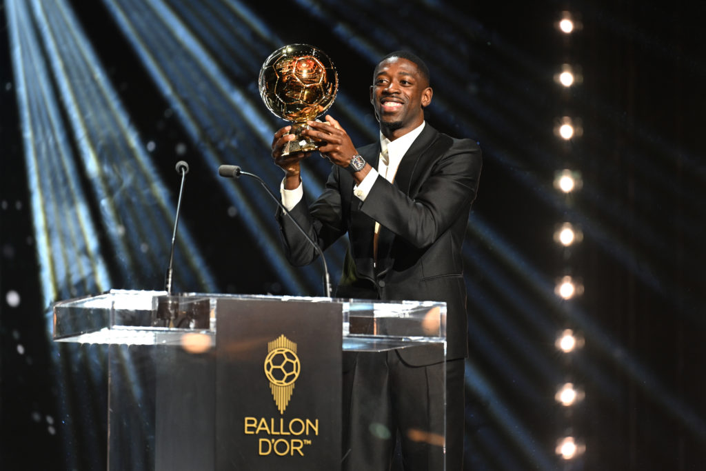 Ousmane Dembele is presented with the Ballon d'Or trophy