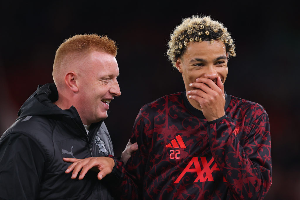 Will Still, head coach of Southampton, shares a joke with Hugo Ekitike of Liverpool