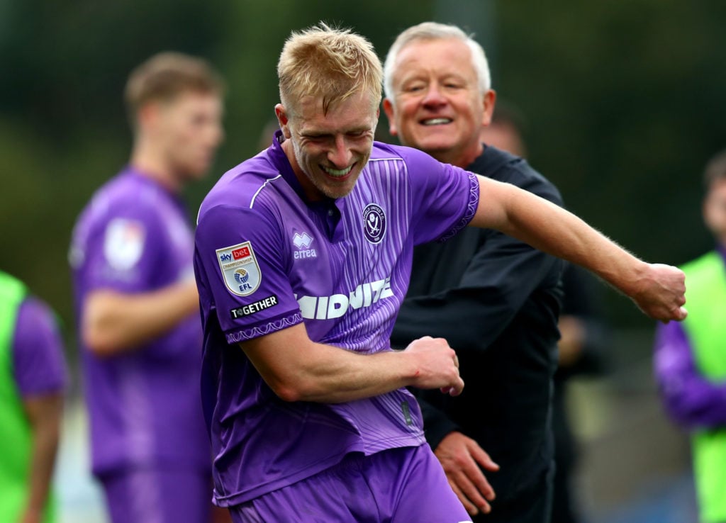 Sheffield United defender Ben Mee alongside manager Chris Wilder after beating Oxford United.