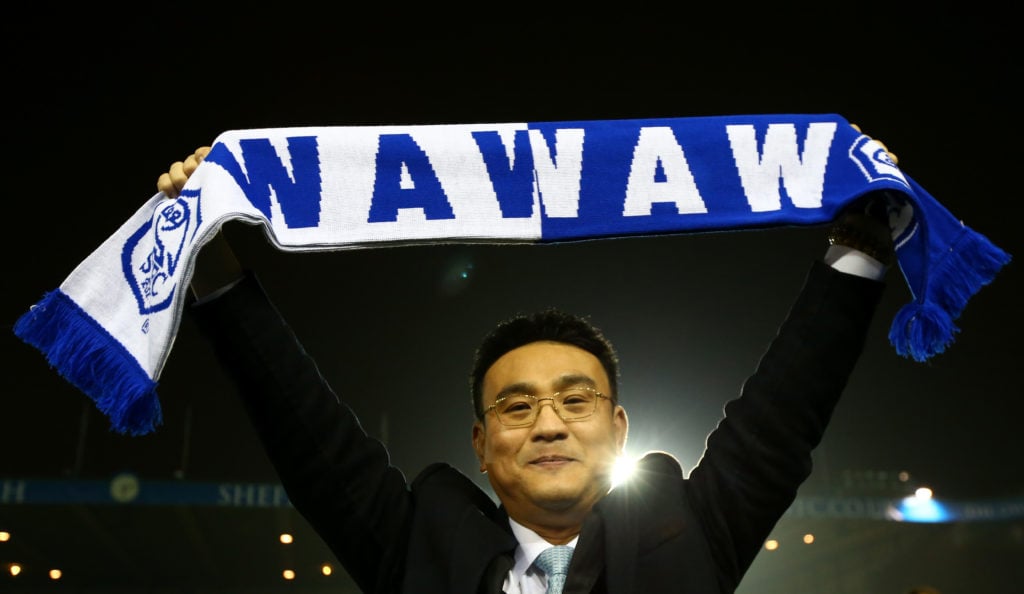 Dejphon Chansiri holds up a Sheffield Wednesday scarf