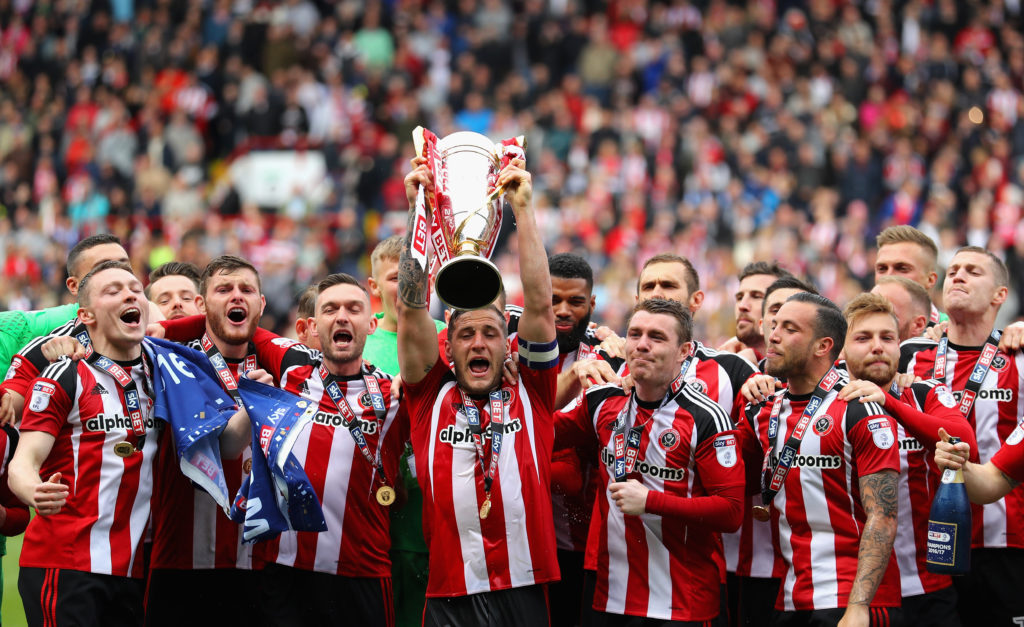 Billy Sharp, Captain of Sheffield United raises the Sky Bet League One trophy and celebrates winning promotion