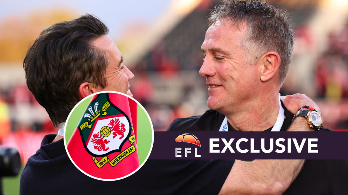 Wrexham co-owner Rob McElhenney and Wrexham manager Phil Parkinson embrace after Wrexham win promotion to the Championship